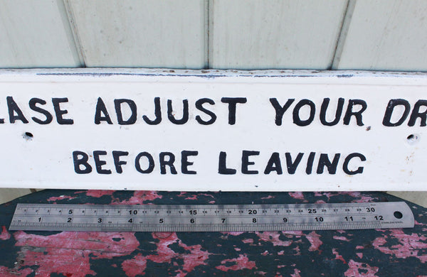 A Cast Iron Victorian Sign "Please Adjust Your Dress" Before Leaving"