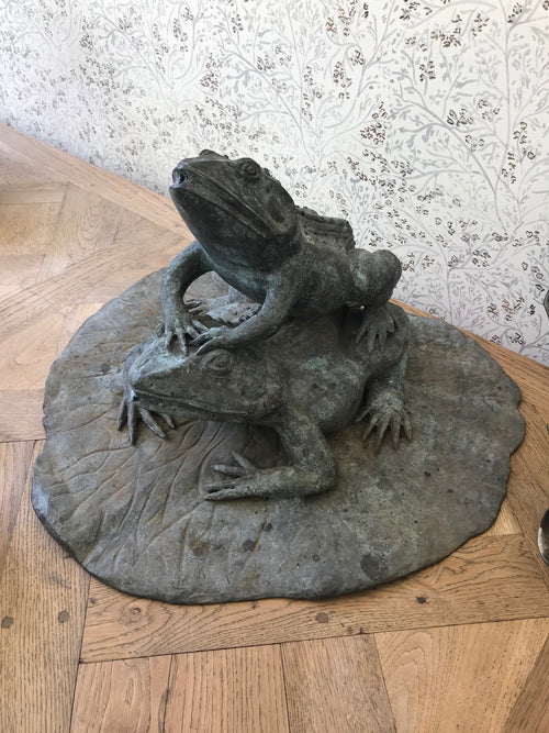 An unusual vintage metal fountain with two mating frogs on a lily pad.