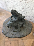 An unusual vintage metal fountain with two mating frogs on a lily pad.