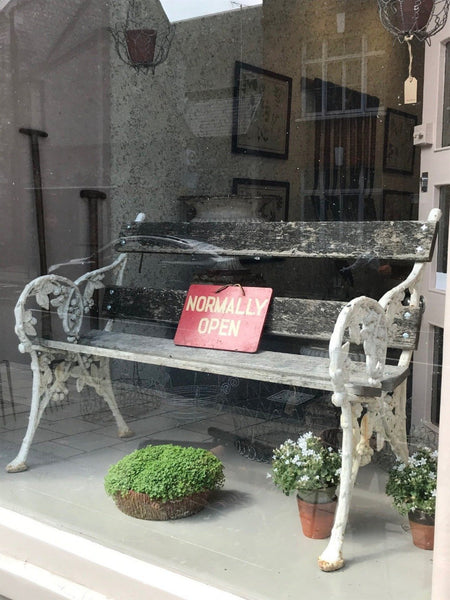 A cast iron garden bench from the Falkirk Foundry with the ends in the form of blackberries and leaves.