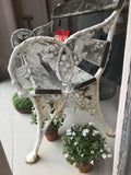 A cast iron garden bench from the Falkirk Foundry with the ends in the form of blackberries and leaves.